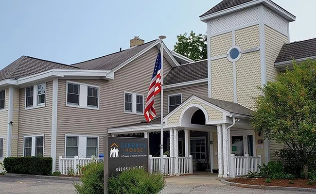 Exterior of Liberty House community residence with an American flag at the entrance